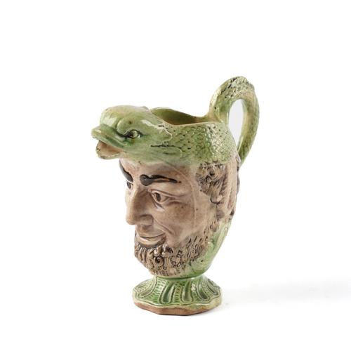 A WOOD TYPE CREAMWARE DOLPHIN HEAD MASK JUG