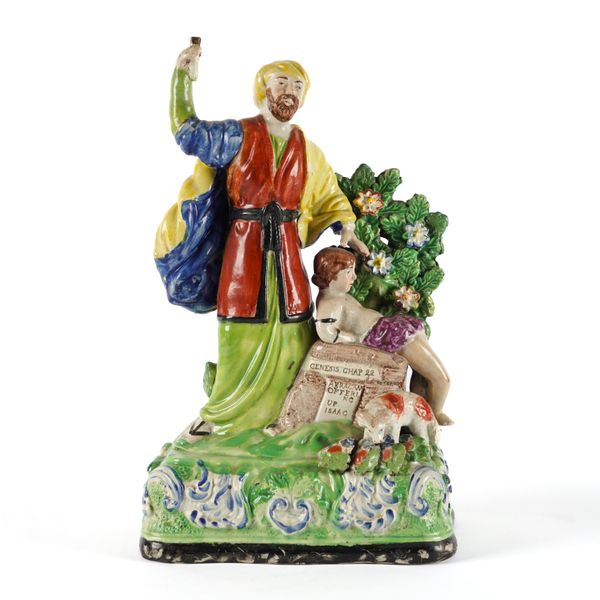 A STAFFORDSHIRE PEARLWARE GROUP OF `ABRAHAM OFFERING UP ISAAC'