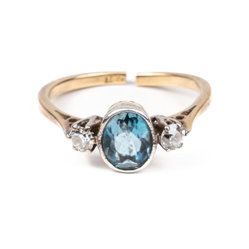 A GOLD, BLUE TOPAZ AND DIAMOND THREE STONE RING