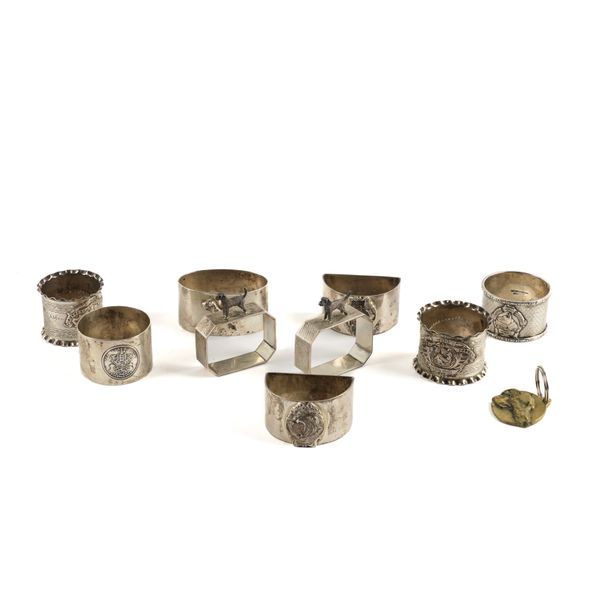 NINE SILVER DOG RELATED NAPKIN RINGS AND A DOG TAG (10)