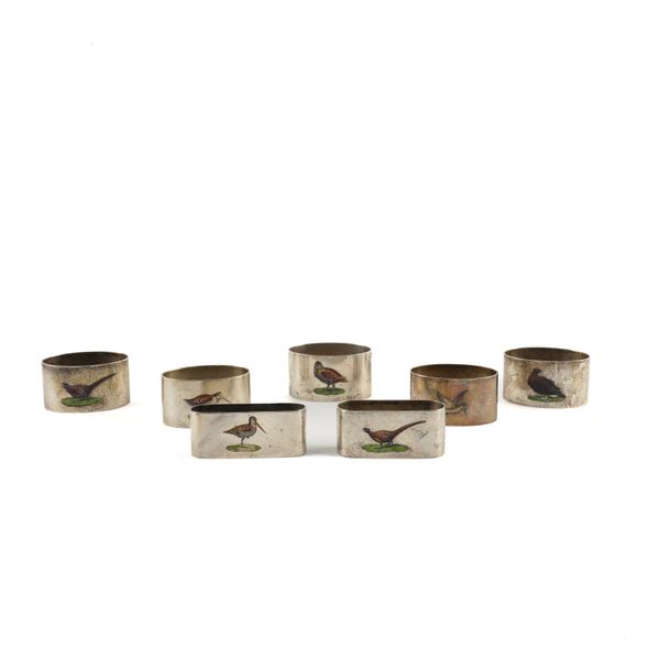 SEVEN SILVER AND ENAMELLED NAPKIN RINGS DECORATED WITH GAME BIRDS (7)