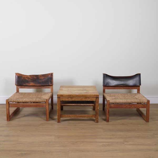 JAVIER CARVAJAL FOR BIOSCA 1963; A PAIR OF OAK FRAMED LEATHER BACKED LOUNGE CHAIRS (3)