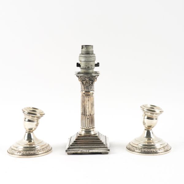 A SILVER CANDLESTICK CONVERTED TO A SMALL TABLE LAMP AND A PAIR OF STERLING CANDLESTICKS (3)