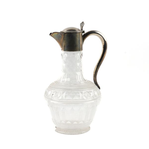 A SILVER MOUNTED FACETED GLASS CLARET JUG