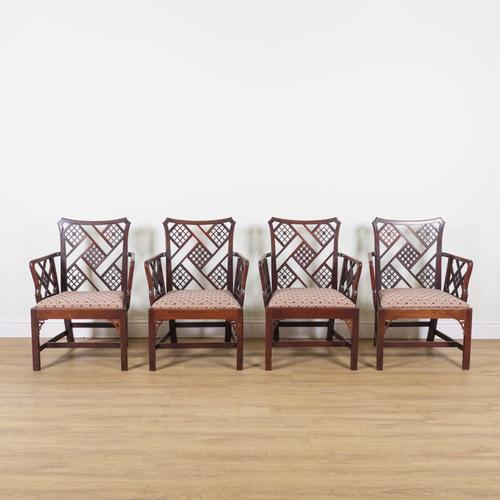 AN UNUSUAL SET OF FOUR GEORGE III MAHOGANY LATTICE BACK OPEN ARMCHAIRS (4)