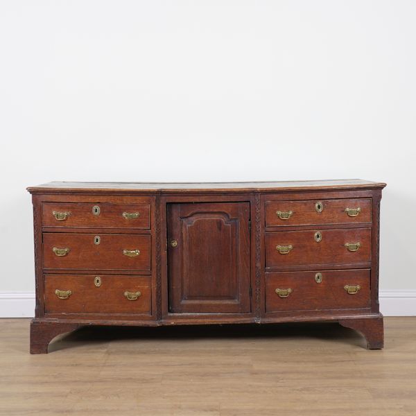 A GEORGE III OAK INVERTED BREAKFRONT DRESSER BASE