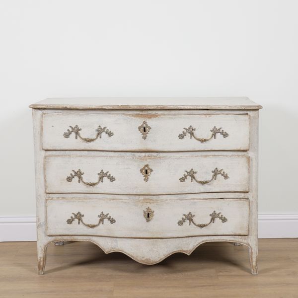 A 19TH CENTURY CONTINENTAL LATER WHITE PAINTED SERPENTINE THREE DRAWER COMMODE