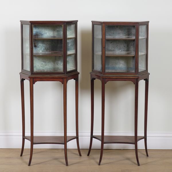 A PAIR OF REGENCY MAHOGANY BRASS MOUNTED SINGLE DOOR GLAZED CABINETS ON STANDS (2)