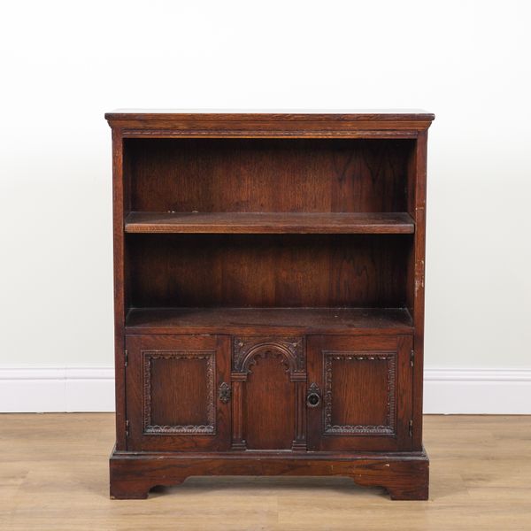 ERCOL; AN OAK BOOKCASE CUPBOARD