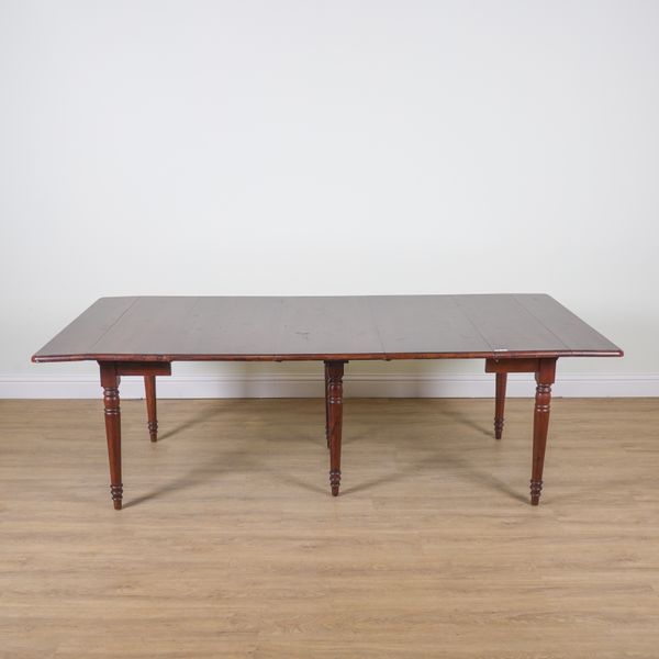 OKA; A WALNUT CONCERTINA ACTION EXTENDING DINING TABLE