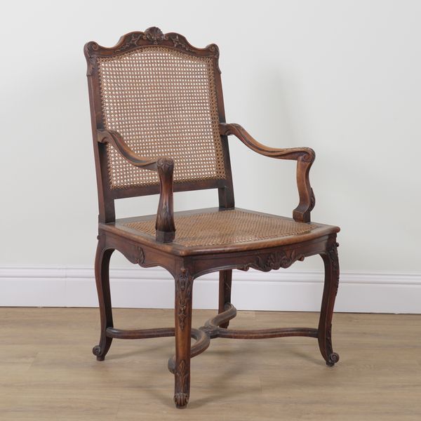 A LOUIS XV STYLE STAINED BEECH CANE OPEN ARMCHAIR