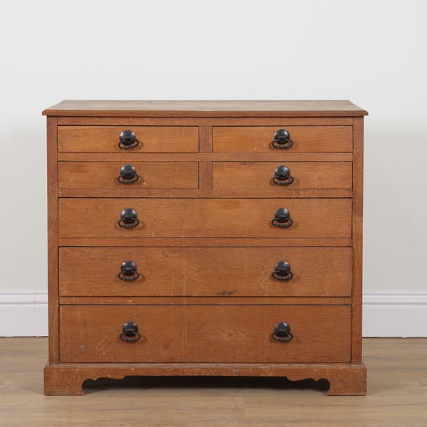 AN ARTS AND CRAFTS OAK SEVEN DRAWER CHEST