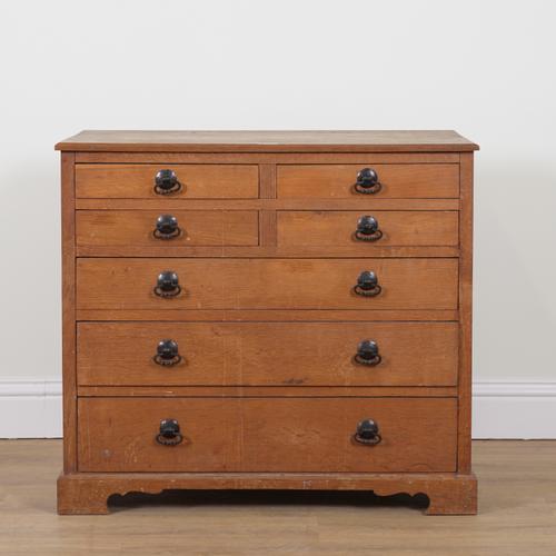 AN ARTS AND CRAFTS OAK SEVEN DRAWER CHEST