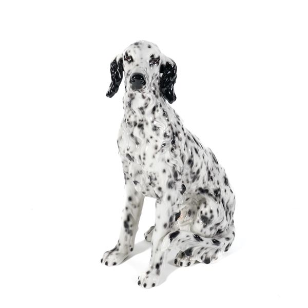 AN ITALIAN CERAMIC FIGURE OF A SEATED ENGLISH SETTER