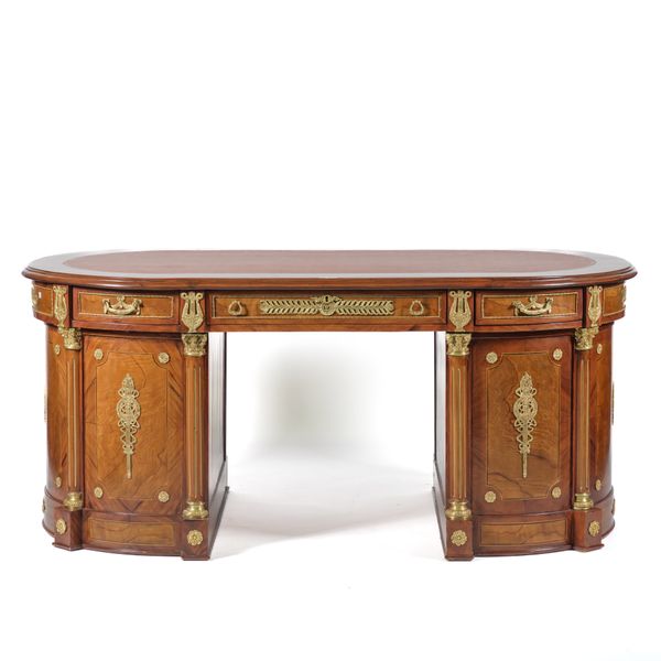 A FRENCH EMPIRE REVIVAL GILT METAL MOUNTED WALNUT ROUNDED RECTANGULAR FREESTANDING PEDESTAL DESK