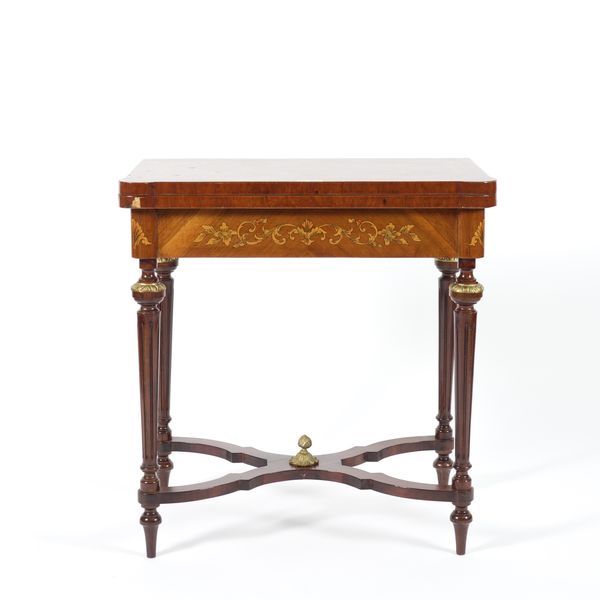 A GILT METAL MOUNTED WALNUT FOLD OVER TEA TABLE