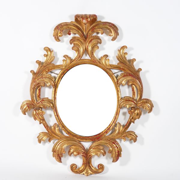 A GILT FRAMED OVAL WALL MIRROR