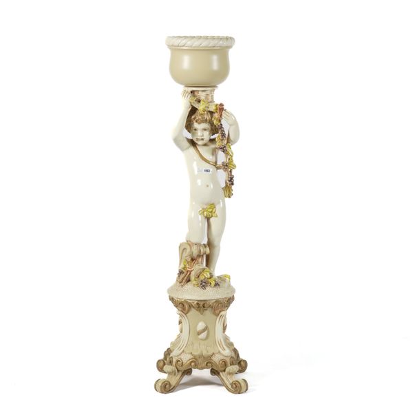 A RESIN CHERUB JARDINIERE STAND