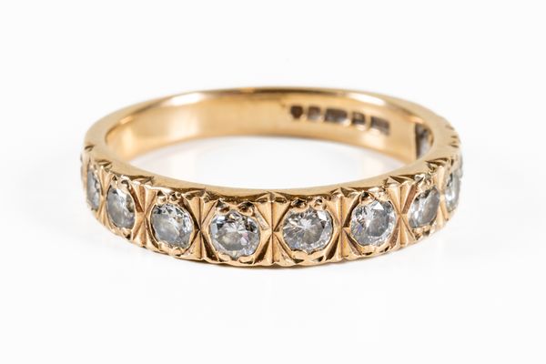 A 9CT GOLD AND DIAMOND ELEVEN STONE HALF ETERNITY RING