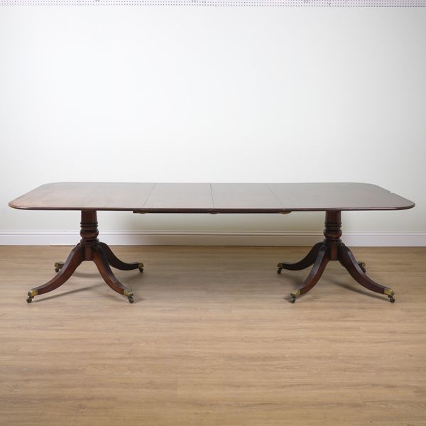 A REGENCY STYLE MAHOGANY TWIN PILLAR EXTENDING DINING TABLE