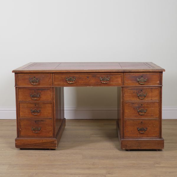 AN EDWARDIAN MAHOGANY NINE DRAWER PEDESTAL DESK