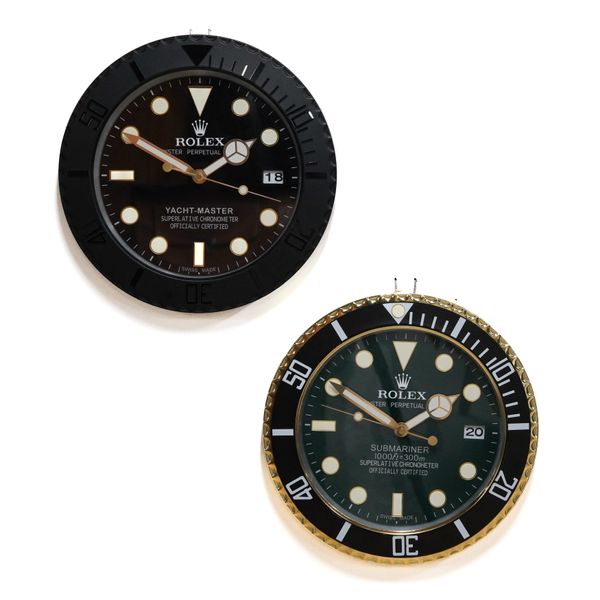 TWO METAL WALL CLOCKS IN THE STYLE OF ROLEX WATCHES: A SUBMARINER AND A YACHT MASTER (2)