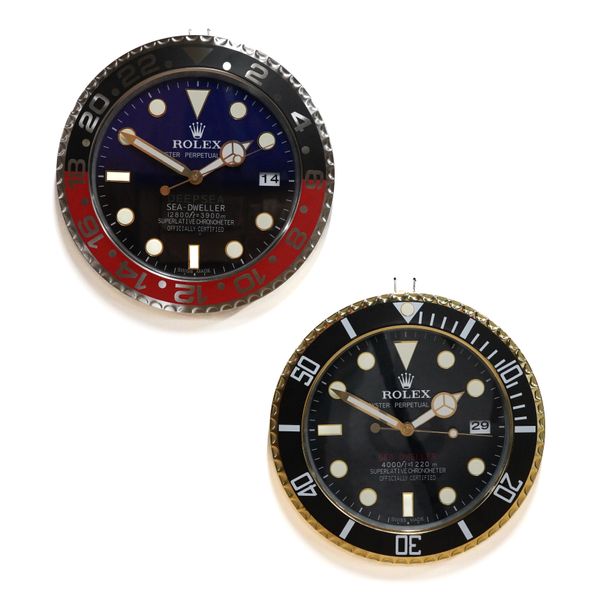 TWO METAL WALL CLOCKS IN THE STYLE OF ROLEX SEA DWELLER WATCHES (2)