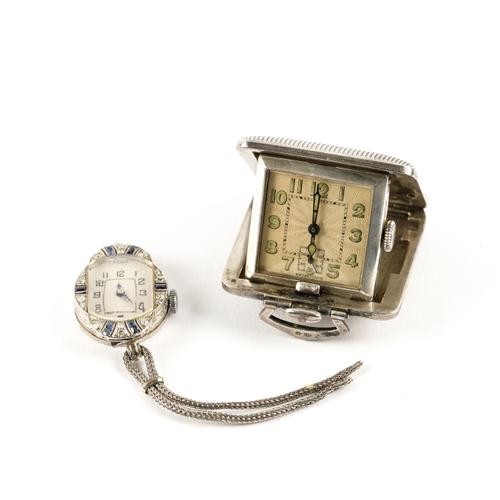 A SILVER CASED TRAVELLING WATCH AND A LADY'S DIAMOND AND BLUE GEM SET DRESS WRISTWATCH (2)