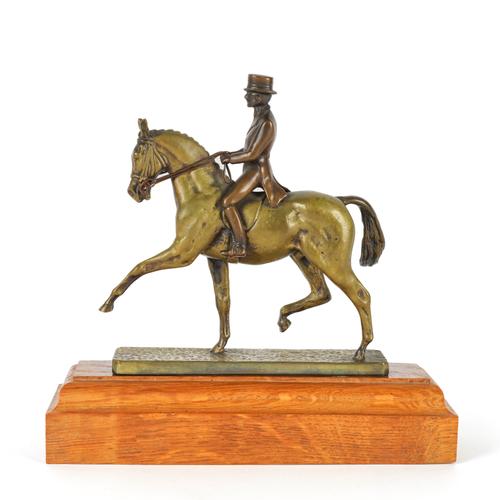 LOUIS LEJEUNE: A PATINATED BRONZE DRESSAGE RIDER AND HORSE CAR MASCOT