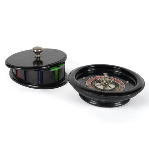 AN EBONISED AND CHROME PLATED ROULETTE WHEEL TOGETHER WITH A FITTED BOX OF GAMBLING CHIPS (2)