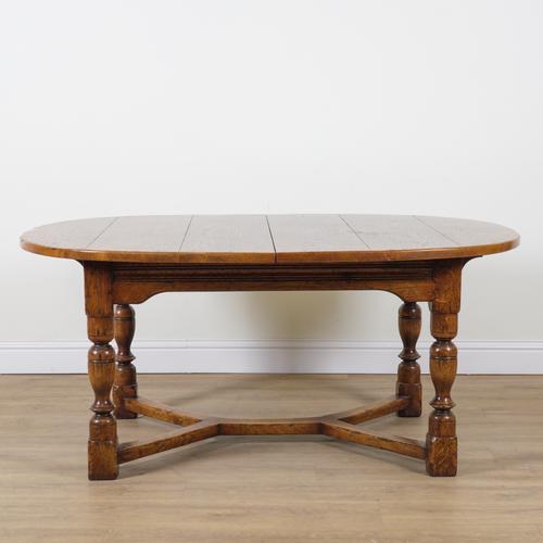 A 17TH CENTURY STYLE OAK DRAWLEAF EXTENDING OVAL DINING TABLE