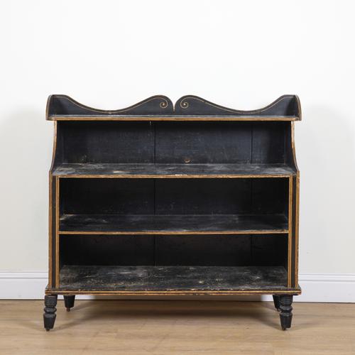 A REGENCY EBONISED PARCEL GILT DECORATED WATERFALL BOOKCASE