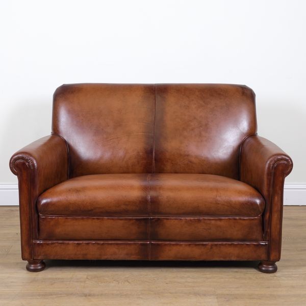 A TAN LEATHER UPHOLSTERED TWO SEAT SOFA