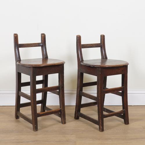 A PAIR OF GEORGE III OAK CHAIR BACK STOOLS (2)