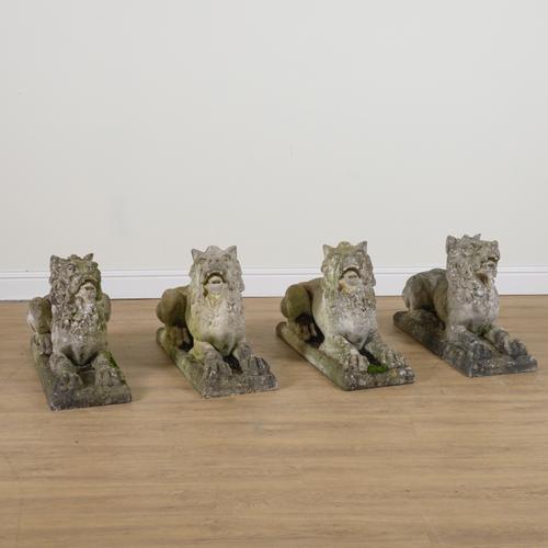 A SET OF FOUR RECONSTITUTED STONE FIGURES OF RECUMBENT BEASTS (4)