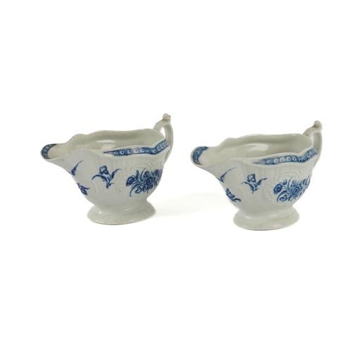 A PAIR OF WORCESTER BLUE AND WHITE PRESS- MOULDED `STRAP FLUTE FLORAL' SAUCEBOATS (2)