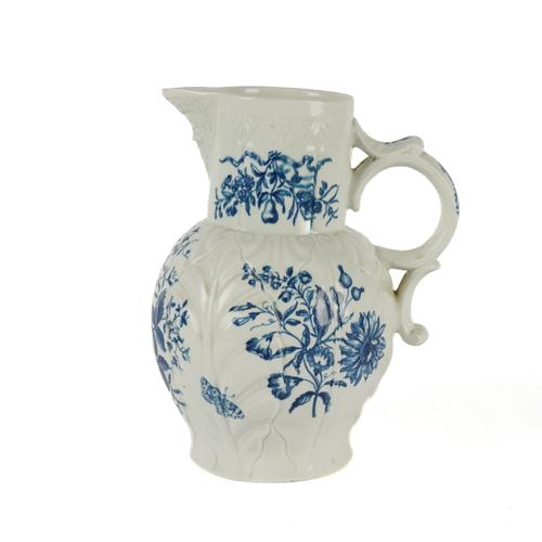 A LARGE WORCESTER BLUE AND WHITE CABBAGE-LEAF MOULDED MASK JUG