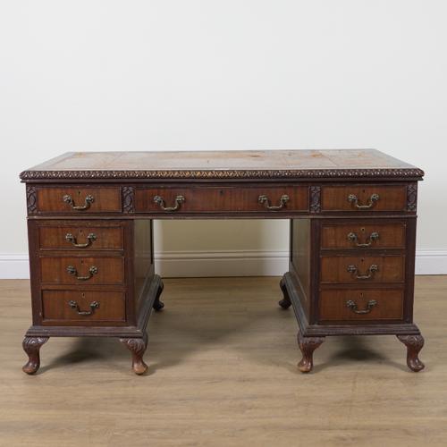 AN 18TH CENTURY STYLE CARVED MAHOGANY NINE DRAWER PEDESTAL DESK