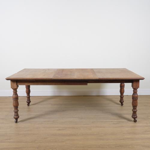 A VICTORIAN OAK EXTENDING DINING TABLE