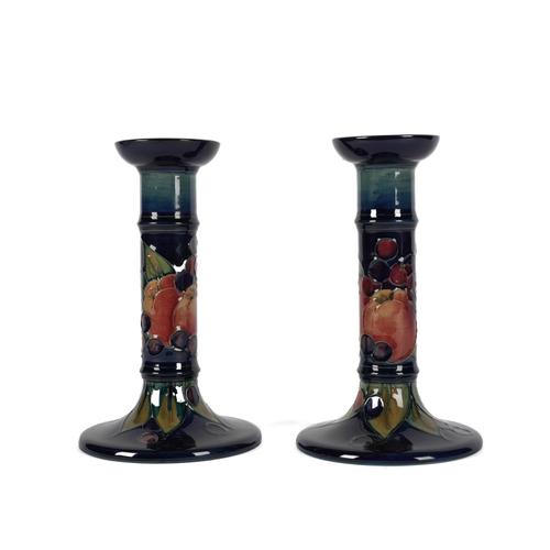 A PAIR OF MOORCROFT POTTERY CANDLESTICKS DESIGNED BY SALLY TUFFIN (2)