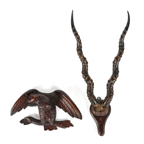 A CONTINENTAL BLACK FOREST CARVED WOODEN BIRD AND A HORN TROPHY (2)