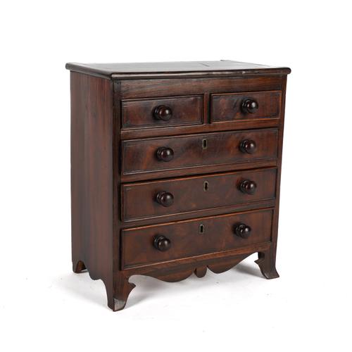 AN APPRENTICE PIECE: A MINIATURE MAHOGANY AND ROSEWOOD CHEST OF DRAWERS