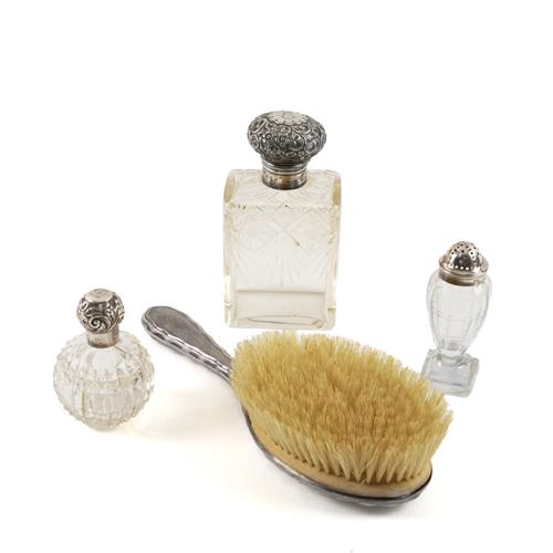 THREE SILVER TOPPED ITEMS OF GLASSWARE AND A SILVER MOUNTED HAIRBRUSH (4)