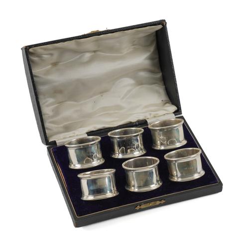 A SET OF SIX SILVER NAPKIN RINGS (6)