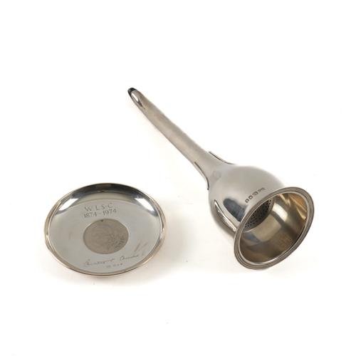 A SILVER WINE FUNNEL AND A SILVER MOUNTED COMMEMMORATIVE DISH (2)