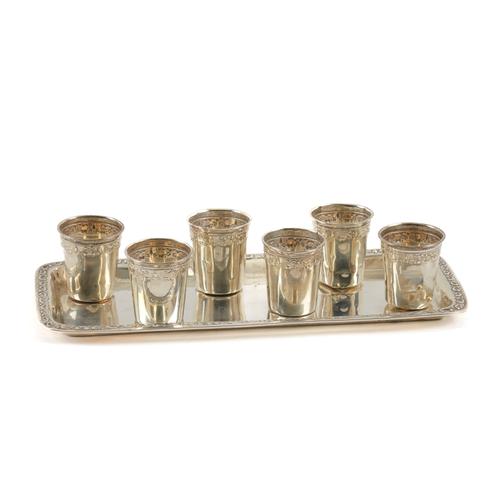 A SILVER RECTANGULAR TRAY AND A SET OF SIX SMALL TUMBLERS (7)