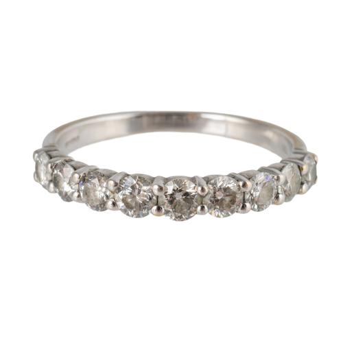 AN 18CT WHITE GOLD AND DIAMOND NINE STONE HALF HOOP RING