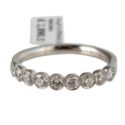 A ROUND BRILLIANT CUT DIAMOND HALF ETERNITY RING