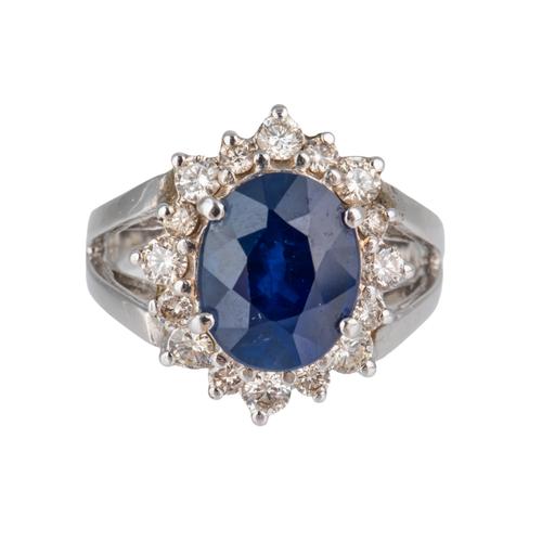 A WHITE GOLD, SAPPHIRE AND DIAMOND OVAL CLUSTER RING