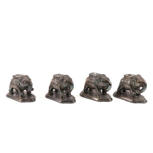 A SET OF FOUR WHITE METAL MOUNTED ELEPHANT STANDS (4)